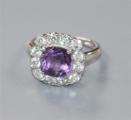 A modern 9ct white gold, amethyst and diamond cluster ring, size J/K.